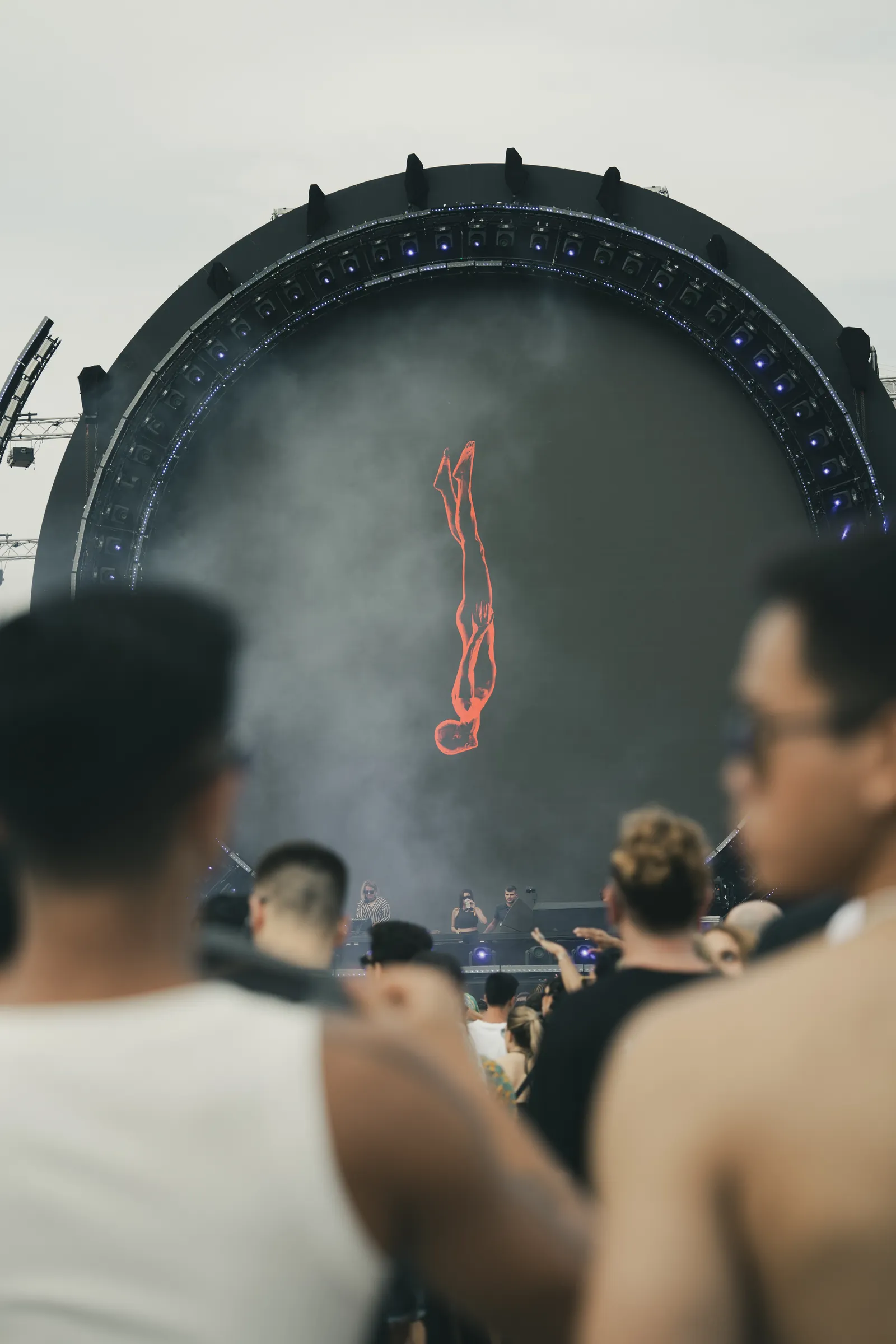 Festival crowd in front of a giant circular LED stage showing a red diving figure at OFF Week Festival in Barcelona