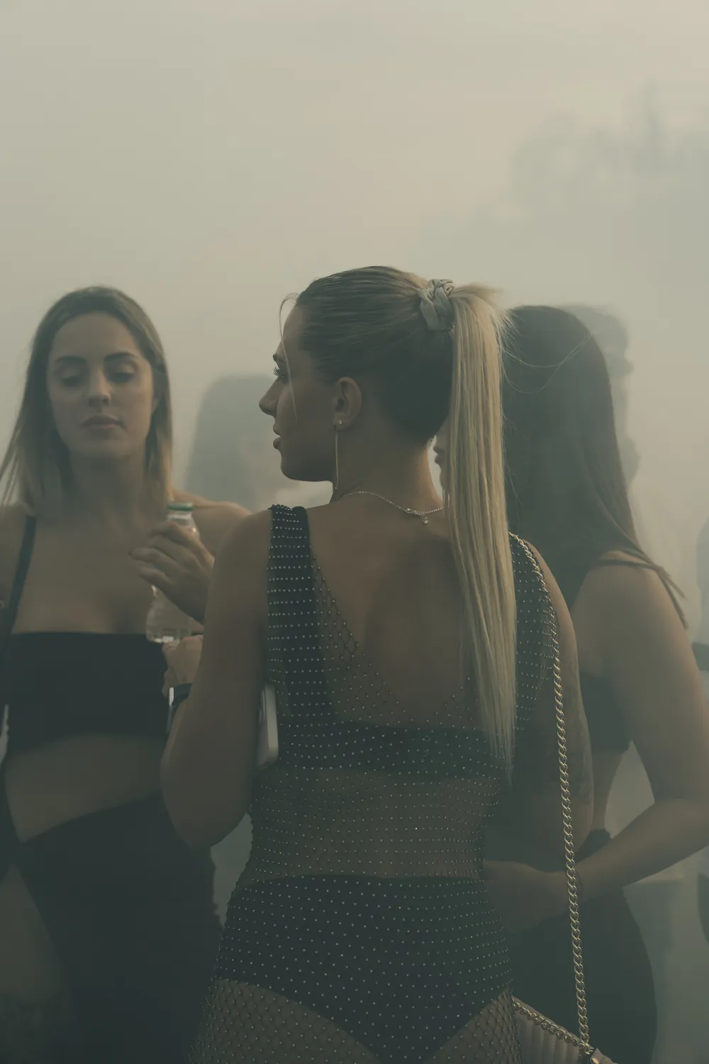 Edited frame of the same women, darker and with more contrast, with muted green shadows and warm cream highlights