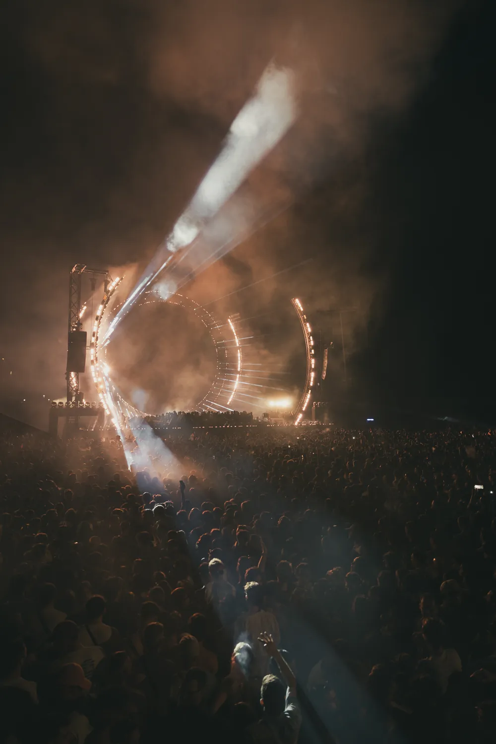 Edited frame of the same stage in warm amber tones with a neutral, darker crowd